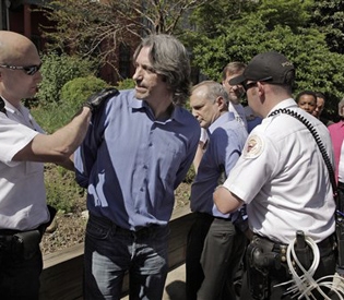 Enough Project co-founder John Prendergast, left, and Save Darfur Coalition president Jerry Fowler, right, are arrested during a protest at the Sudanese Embassy against the actions by the Sudanese government in Darfur on Monday in Washington.